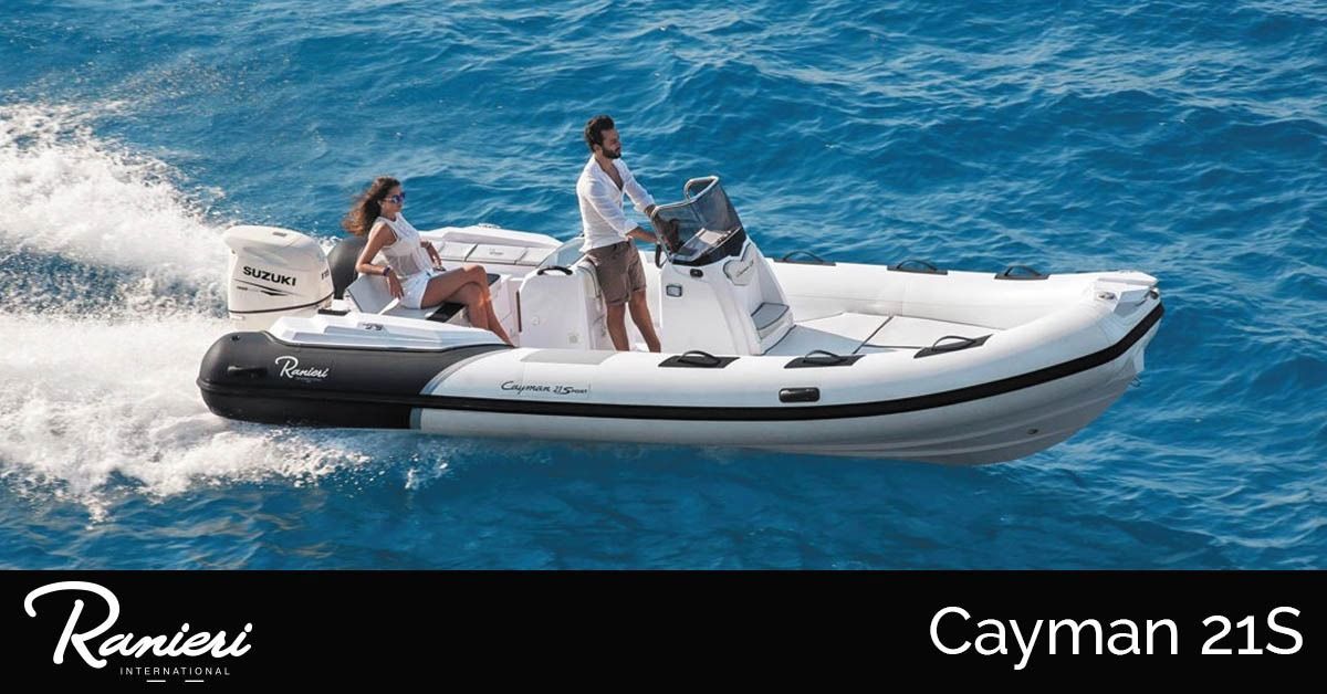 White inflatable speedboat on blue water, towing two riders; Cayman 21S banner at bottom.