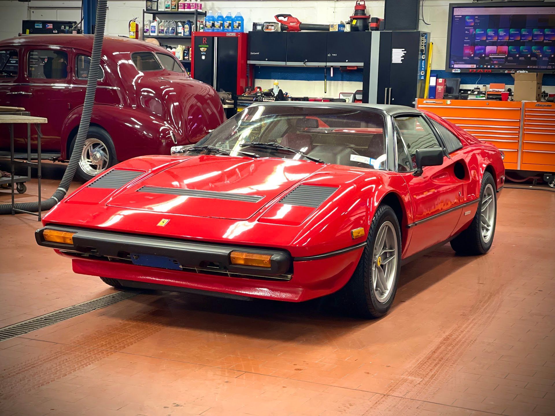 A Red Ferrari Sports Car is Parked in a Garage | Motorwerks Inc