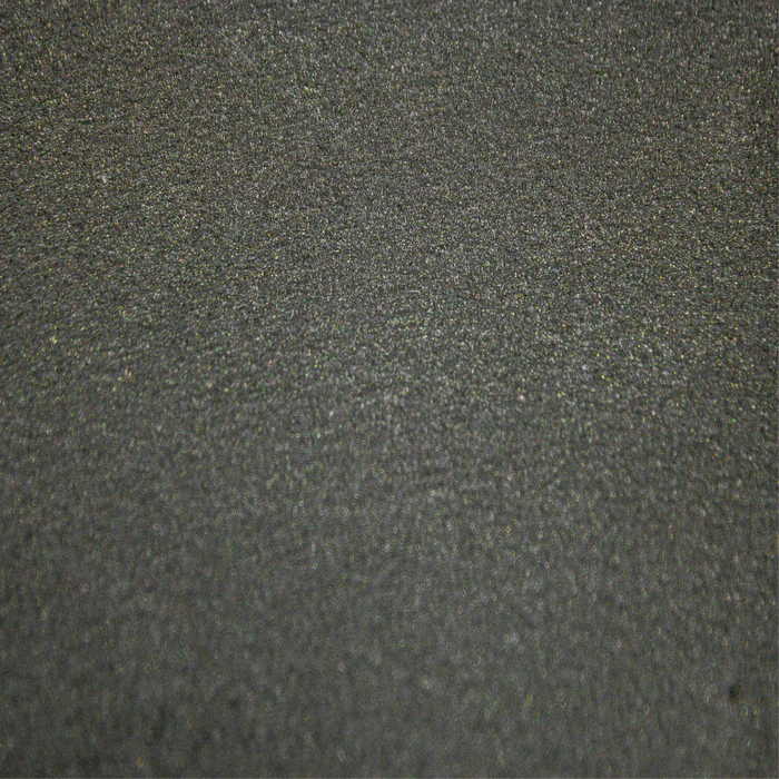 A close up of a black surface with a grainy texture