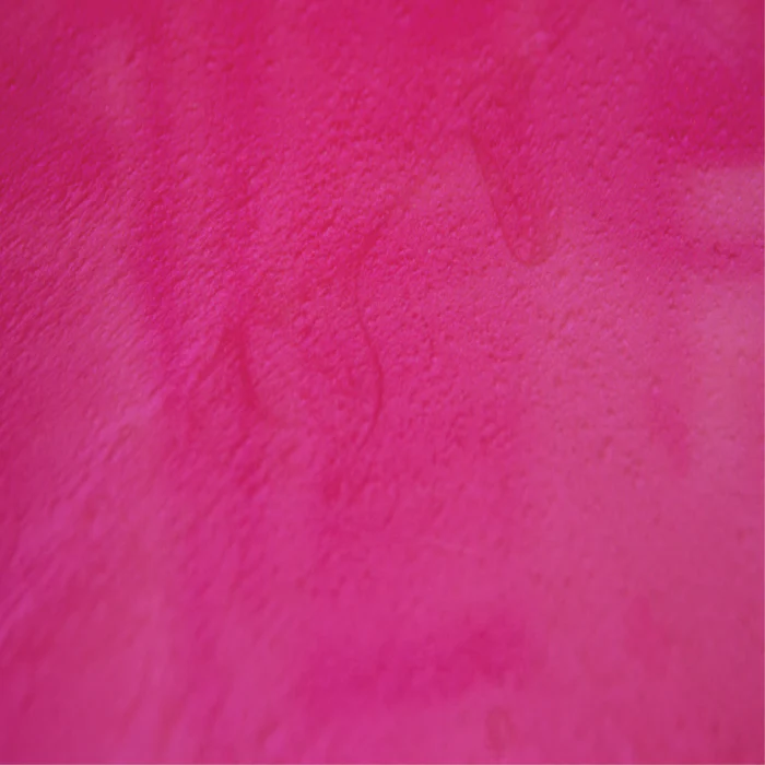 A close up of a pink paper texture.