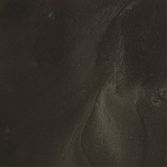 A close up of a black tile with a marble texture.