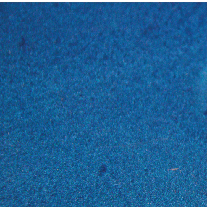 A close up of a blue surface with a grainy texture