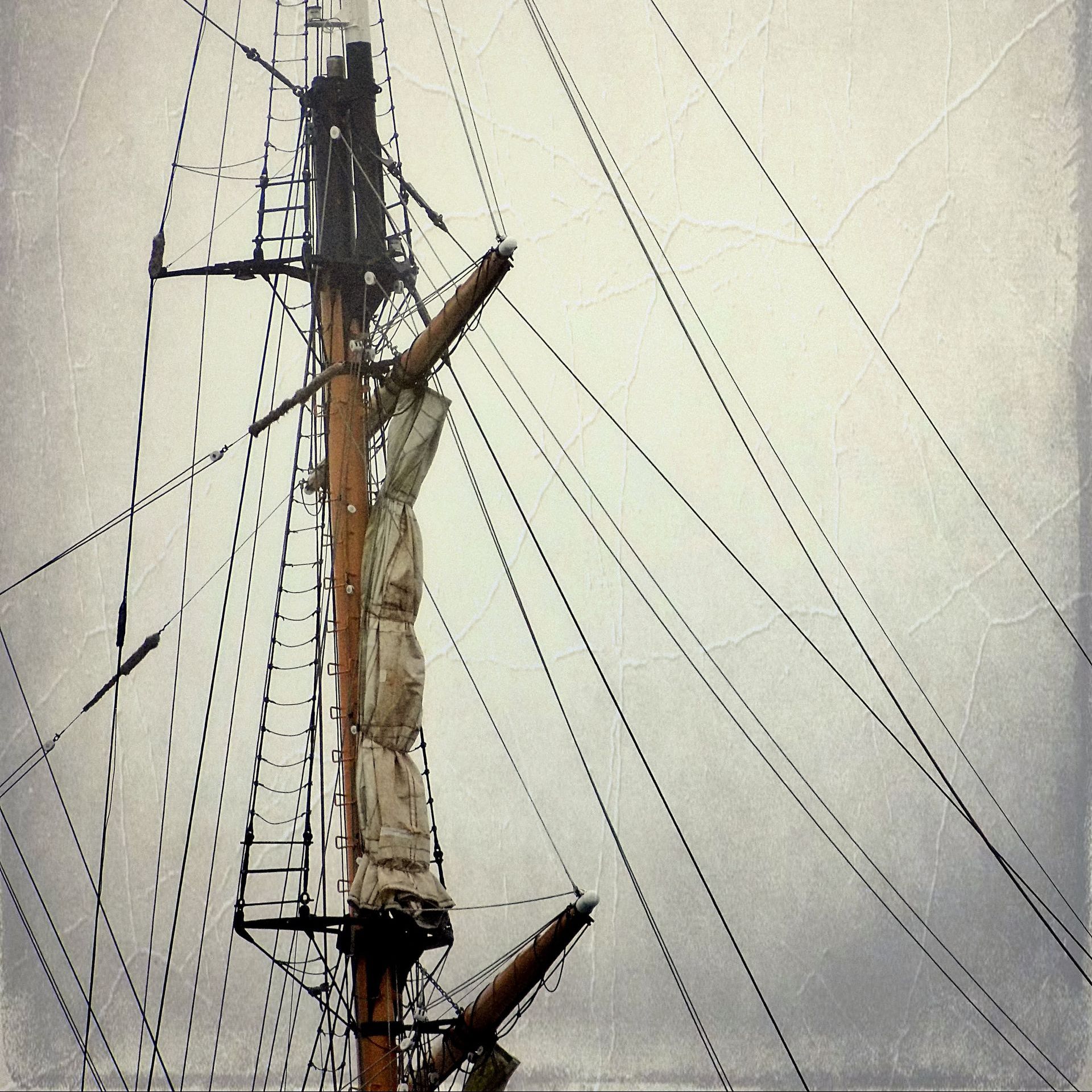A sailboat mast with a white sail on it
