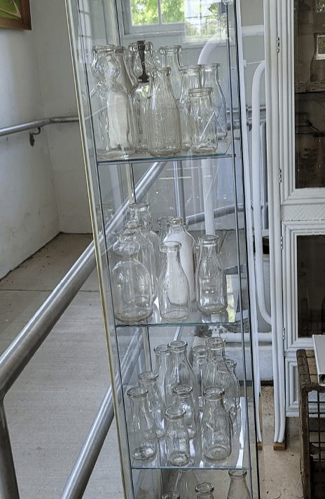 A glass display case filled with milk bottles