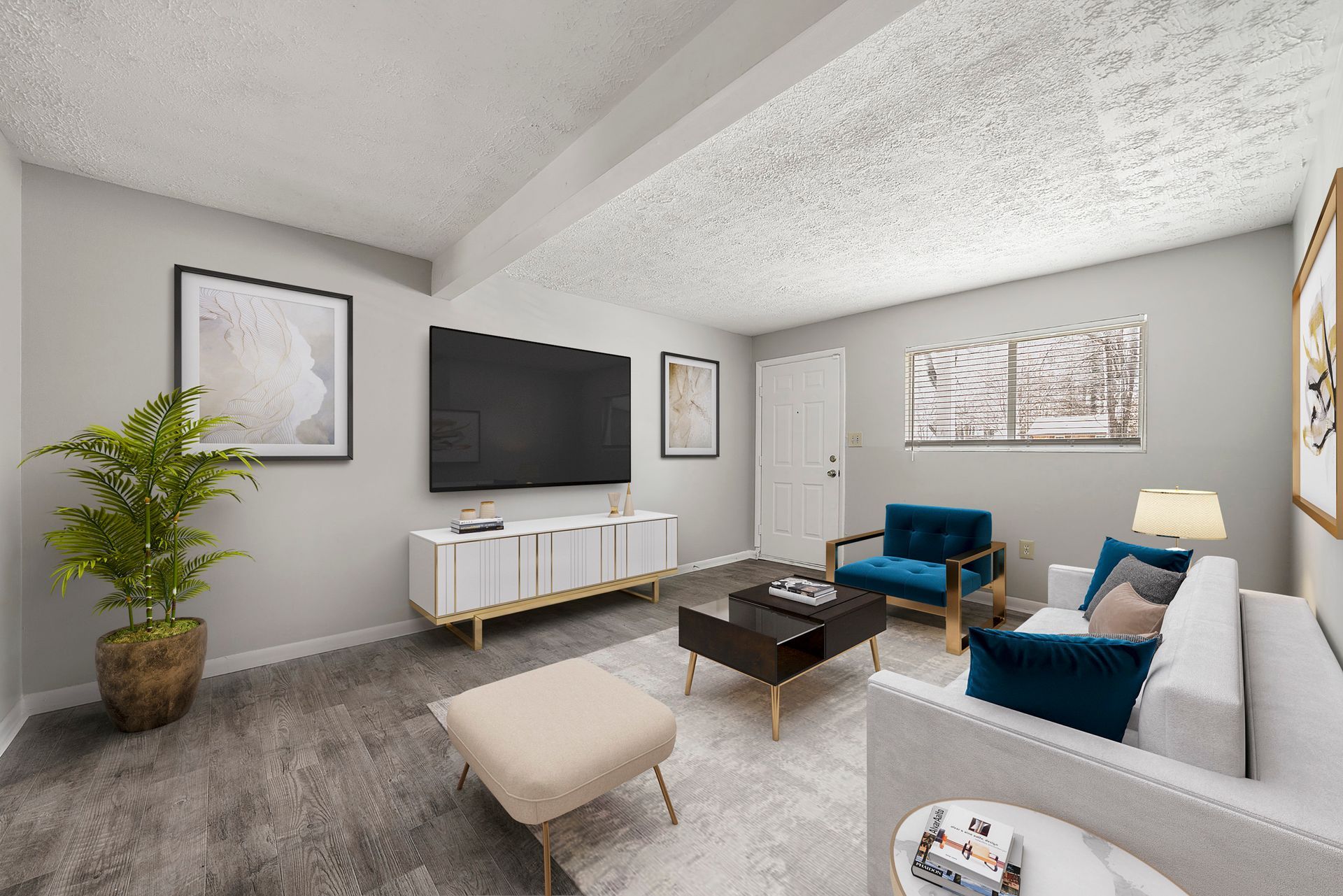 Modern living room with gray sofa, blue chairs, wall-mounted TV, and light wood console.