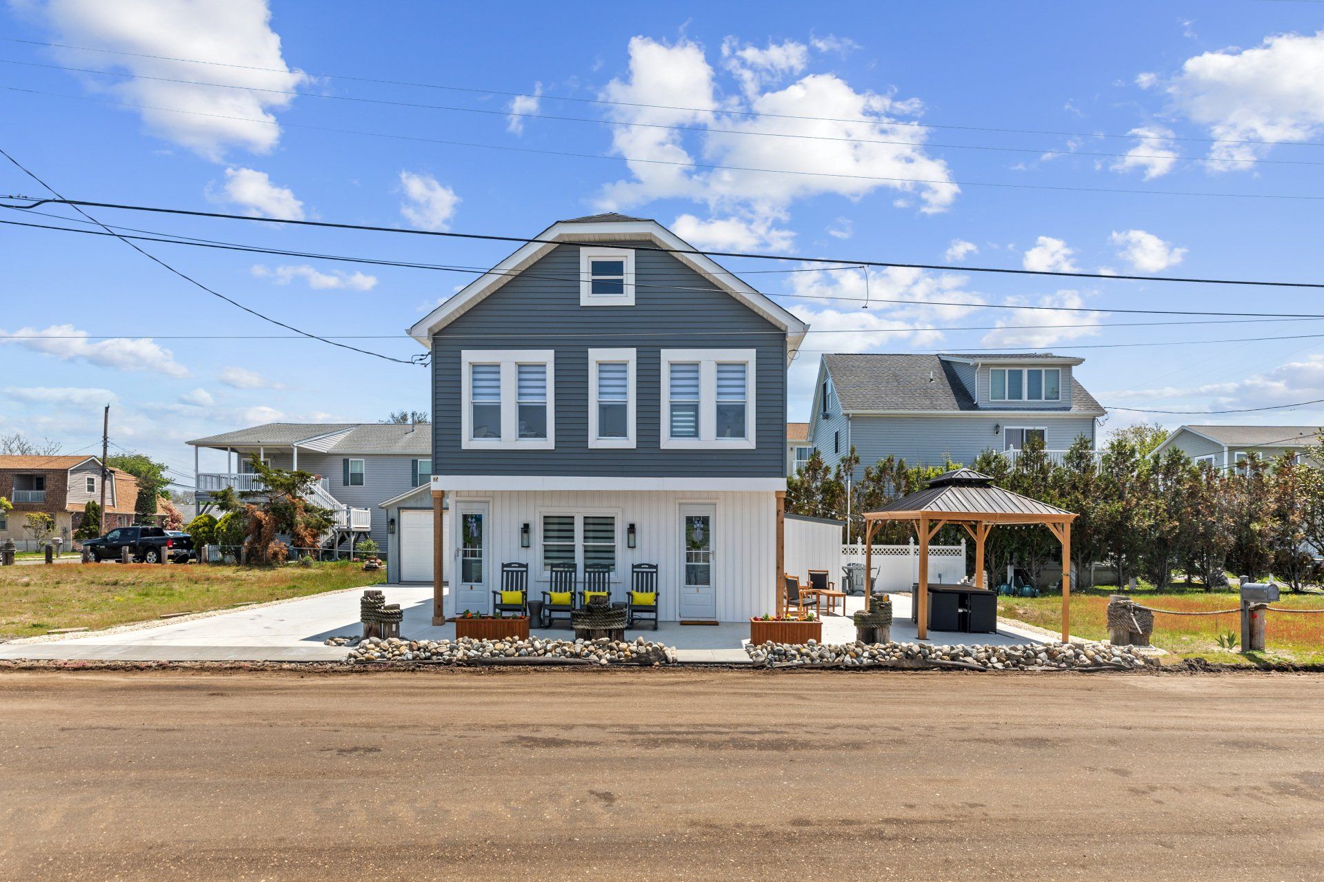 Cape May  Bayside Love rental A large gray and white house with a gazebo in front of it.