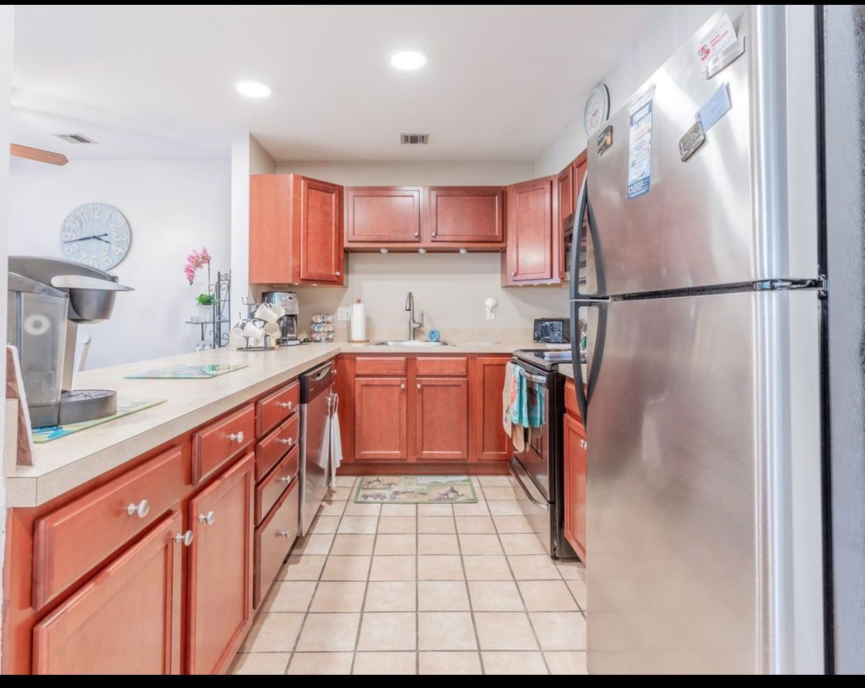A kitchen with stainless steel appliances and wooden cabinets
