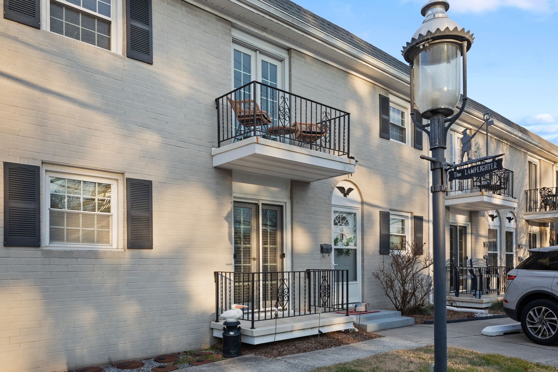 A building with a balcony and a lamp post in front of it