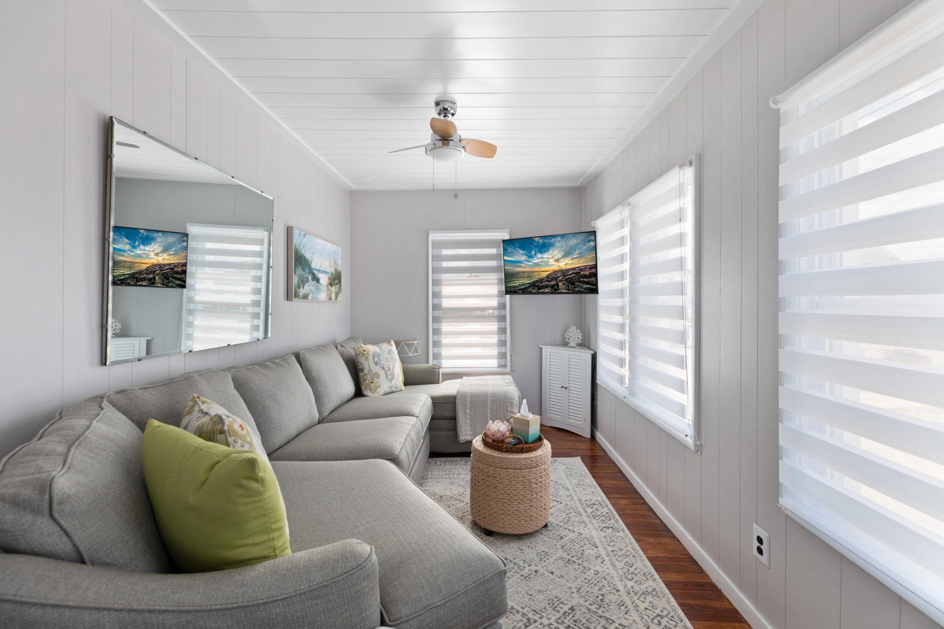 Cape May  Bayside Love rental  living room with a couch , chair , and a ceiling fan.