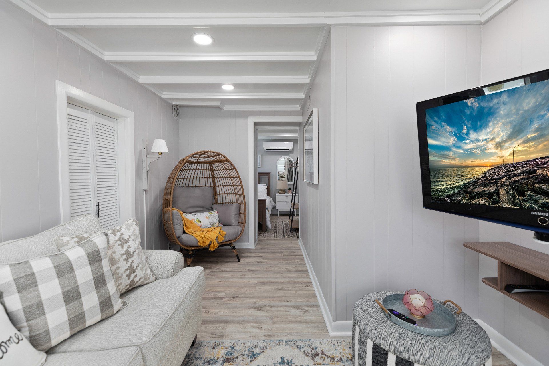 Cape May  Bayside Love rental  living room with a couch , chair , table and television.
