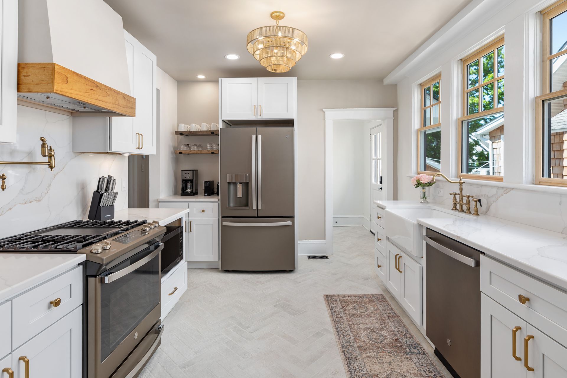 A kitchen with stainless steel appliances and white cabinets.