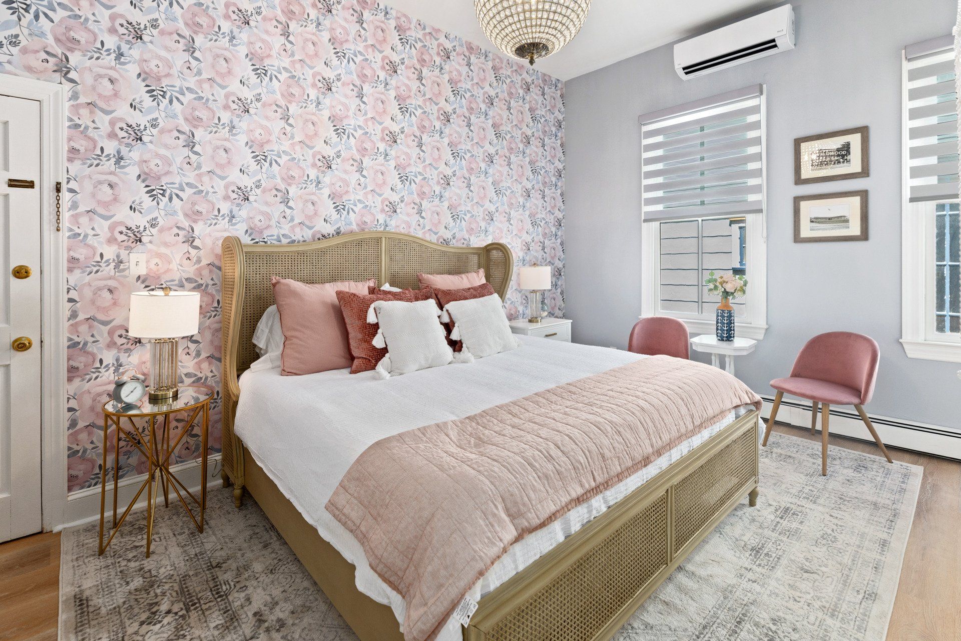 A bedroom with a large bed and floral wallpaper