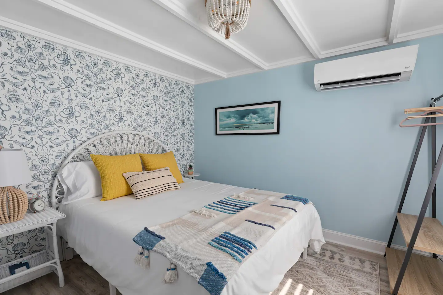 A bedroom with a bed , nightstand , and air conditioner.