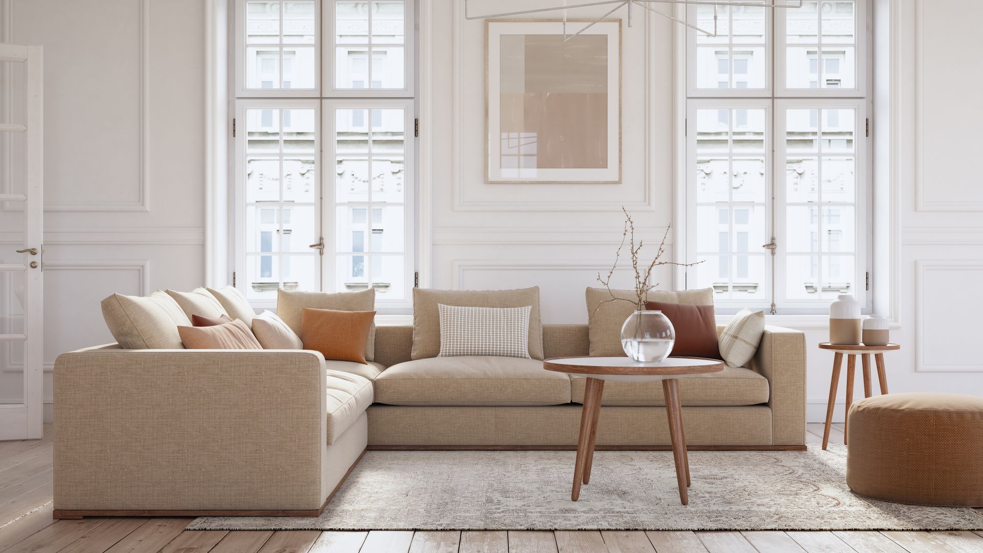 Divano componibile beige in un luminoso soggiorno con ampie finestre e dettagli in legno.