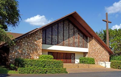 A large church with a cross on top of it