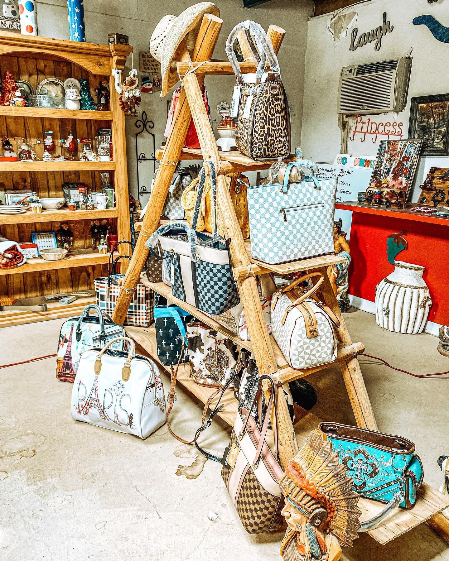 Wicker ladder display with beach bags and decor in a bright gift shop