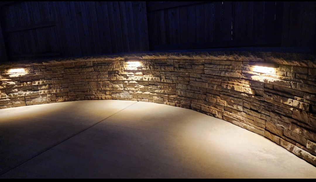 Retaining wall with cap and lighting.