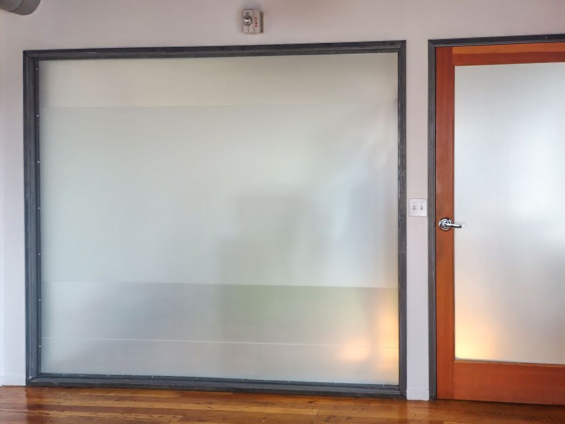 A room with a door and a window with frosted glass.