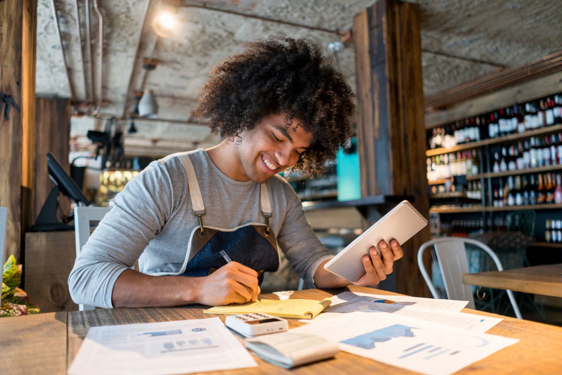 Happy Man Working at a Restaurant Using a Tablet Computer — Spartanburg, SC — S. Reel Robertson, CPA, PA