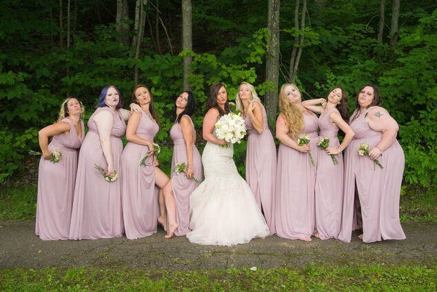 A bride and her bridesmaids are posing for a picture.