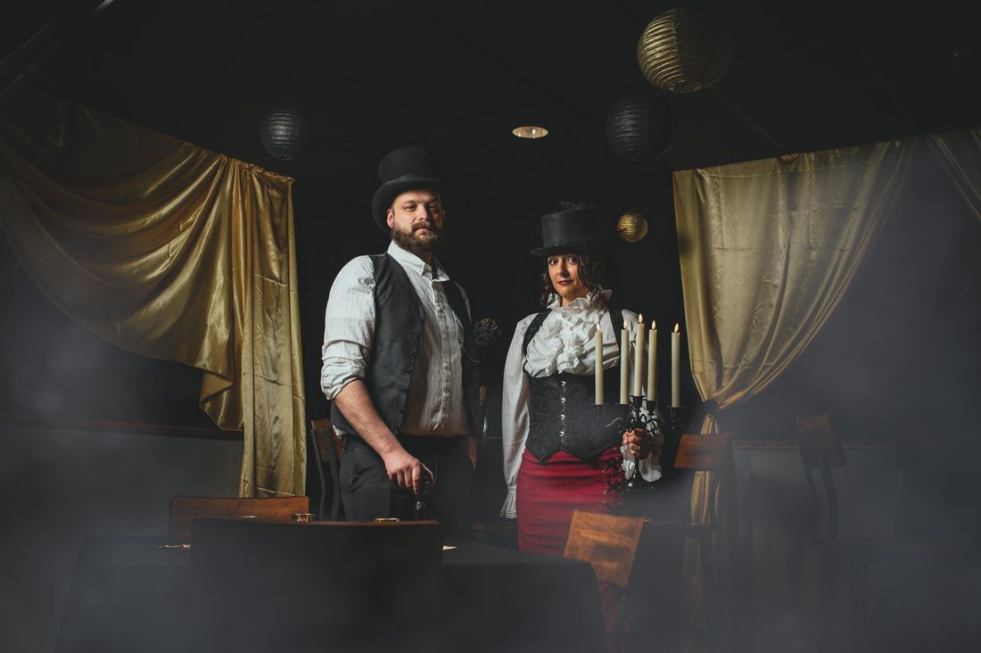 A man and a woman are standing next to each other in a dark room.