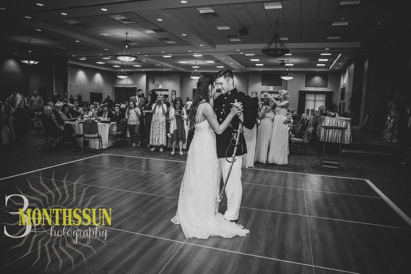 A bride and groom are dancing on a dance floor at their wedding reception.