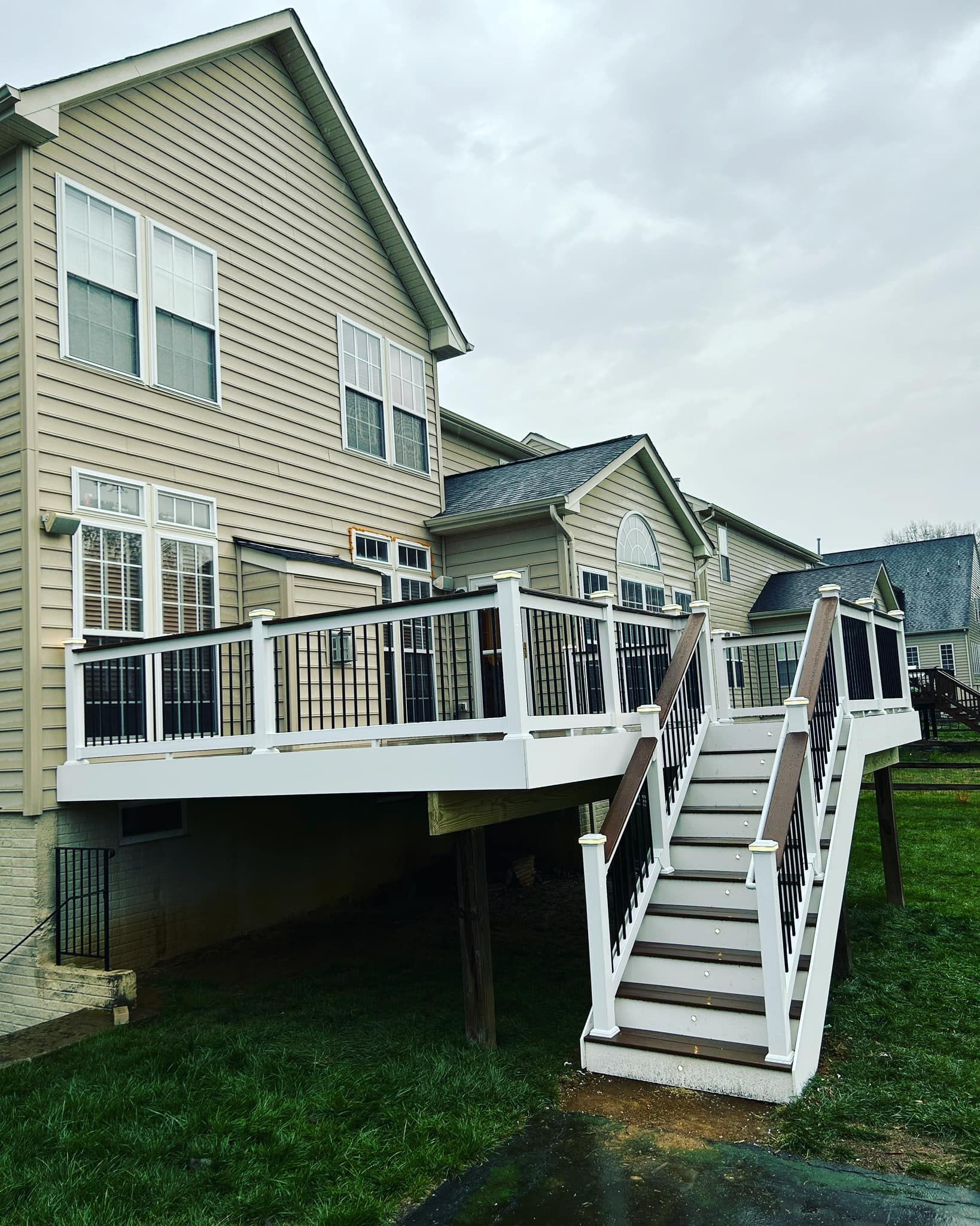 A house with a deck and stairs in front of it