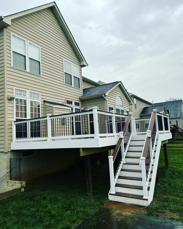A house with a deck and stairs in front of it