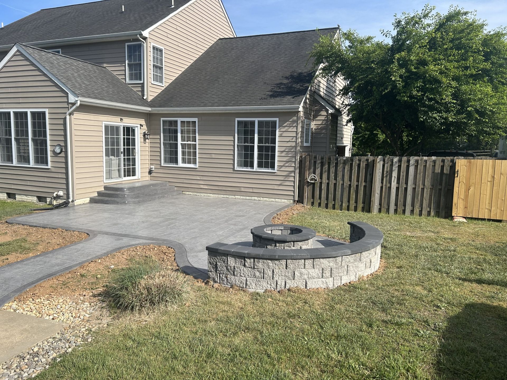 A house with a fire pit in front of it.