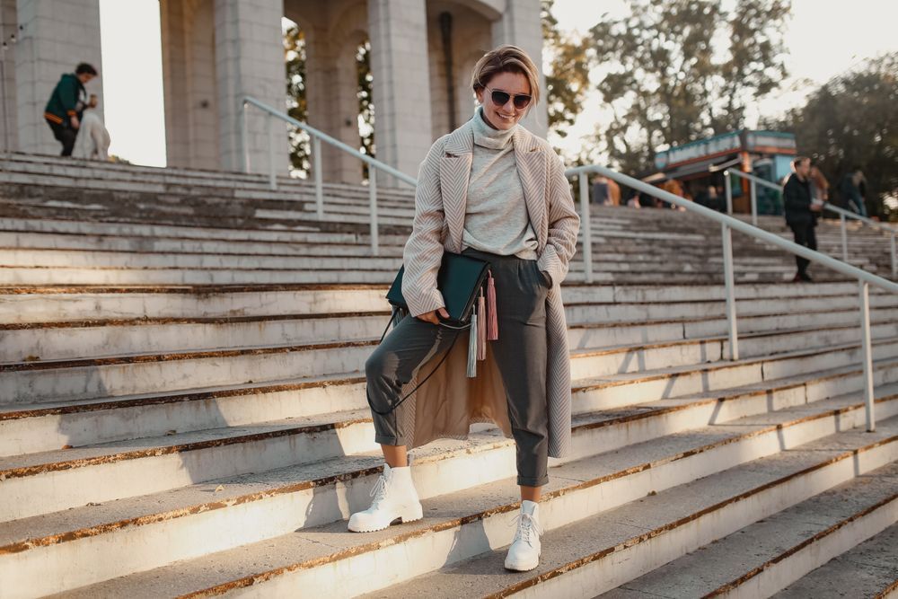 A woman is standing on a set of stairs.
