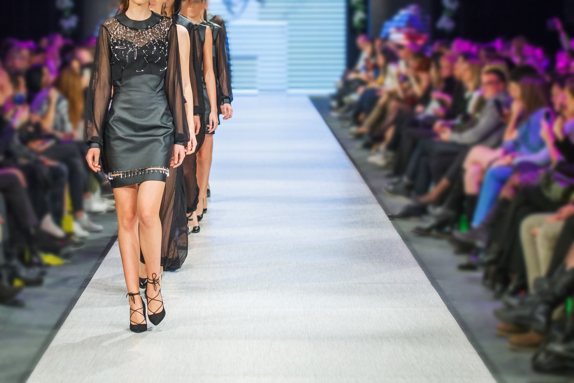 a group of women are walking down a runway at a fashion show to help build a brand through a runway show