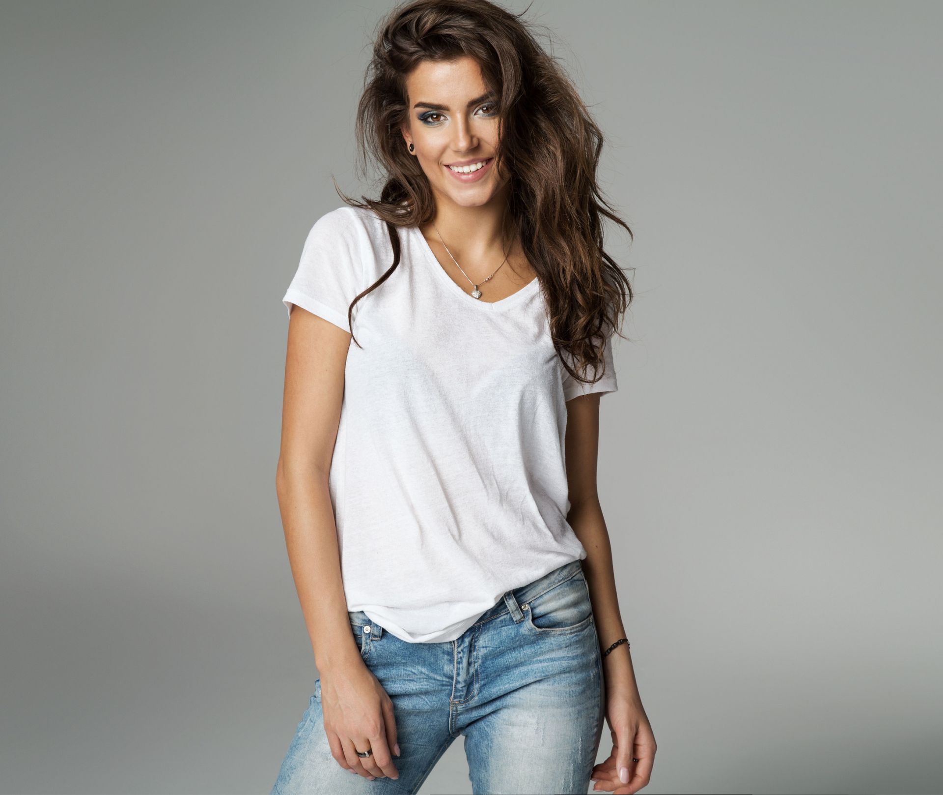 white t-shirt is styled with jeans