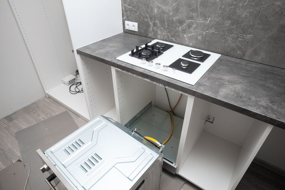 Kitchen Under Construction: White Cabinets, Gray Countertop — Carl Voss Electrical In Urangan, QLD