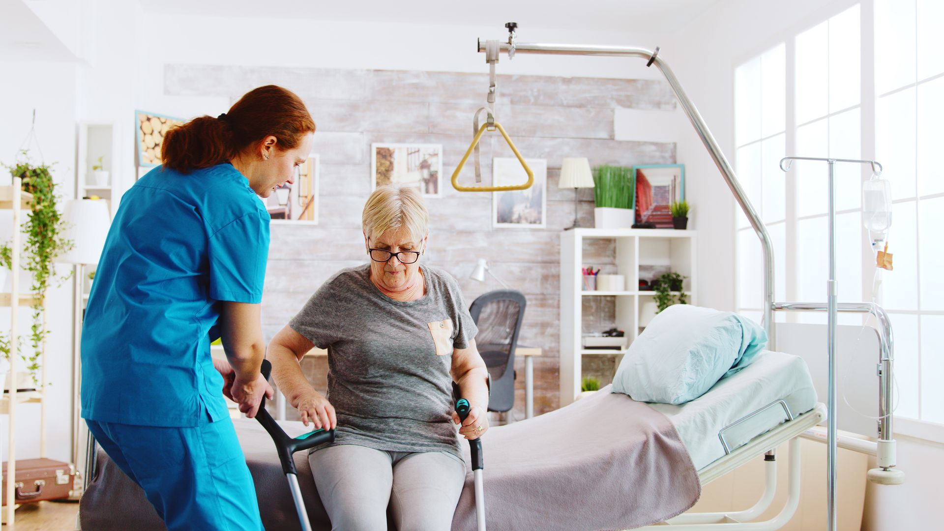 home nurse assisting with mobility equipment in hom