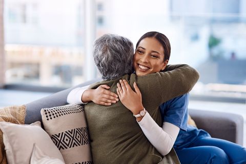 home nurse hugging patient in home