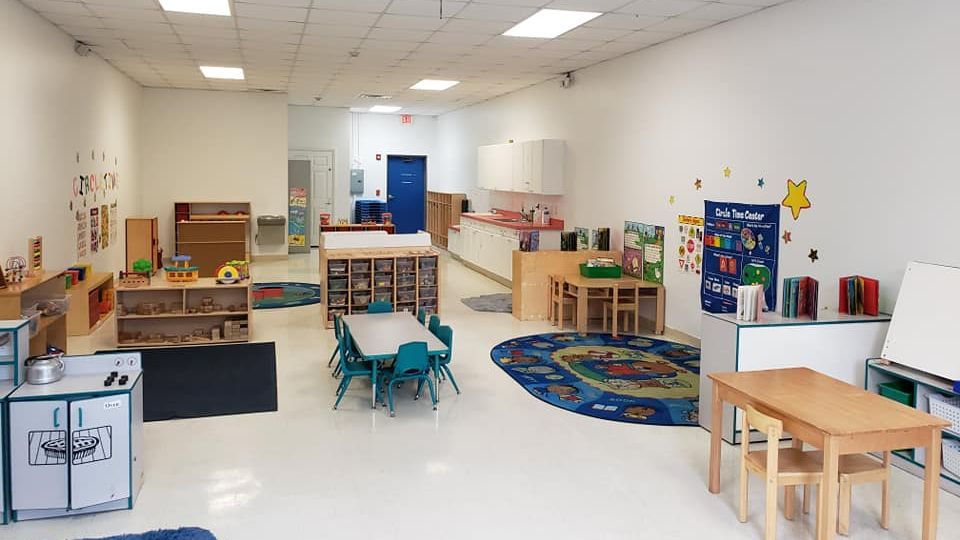 A large room with tables and chairs in it