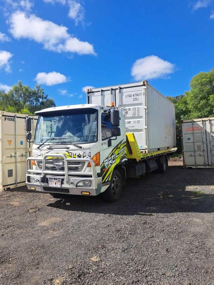 A White Truck With a Yellow Tow Hook is Parked in a Gravel Lot — Pro-Tow Toowoomba In Wilsonton, QLD