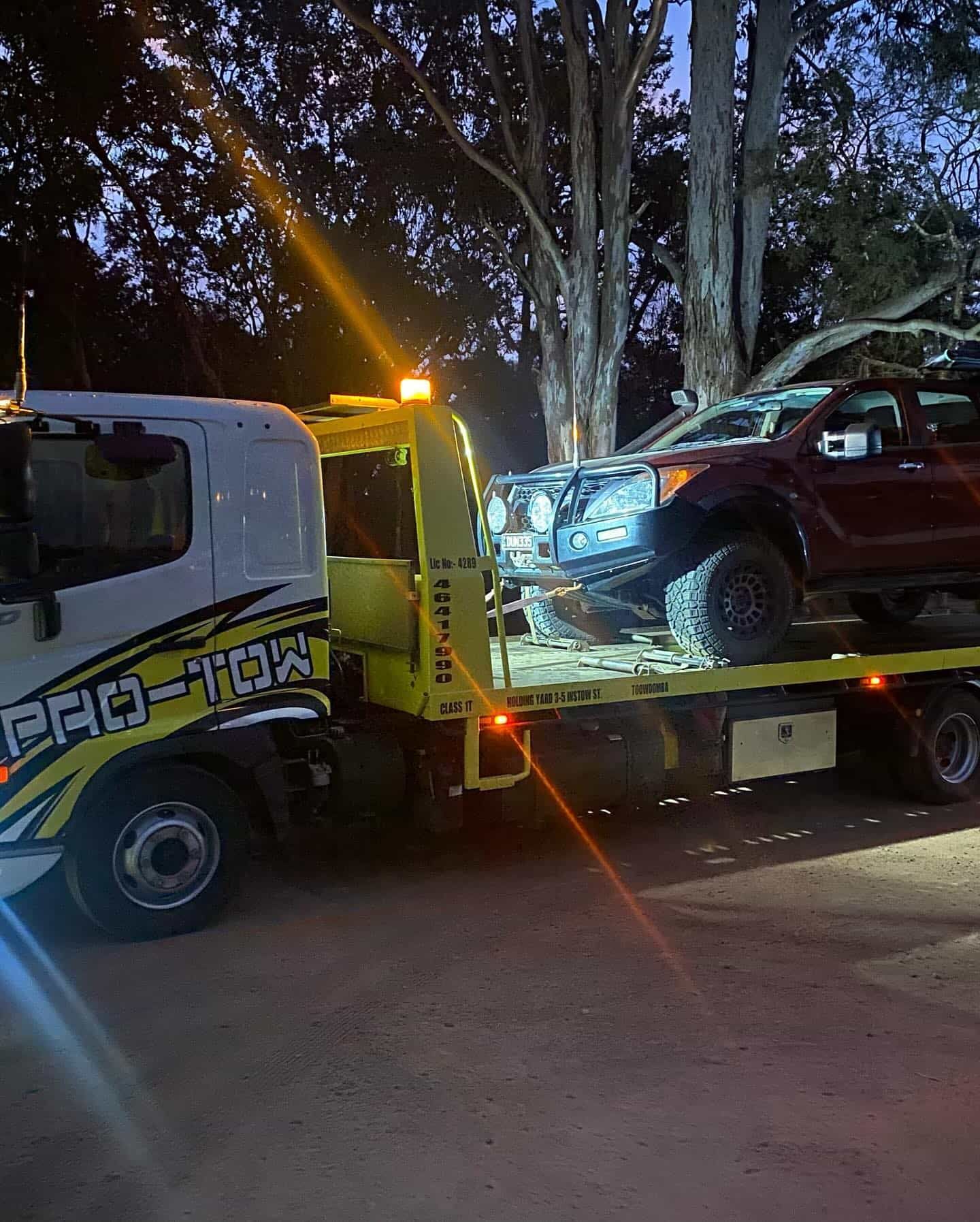 A Tow Truck Loads a Dark-colored SUV — Pro-Tow Toowoomba in Wilsonton, QLD