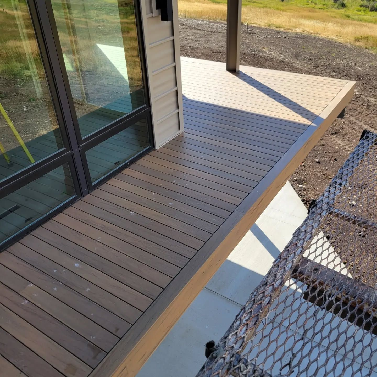 An aerial view of a wooden deck next to a house