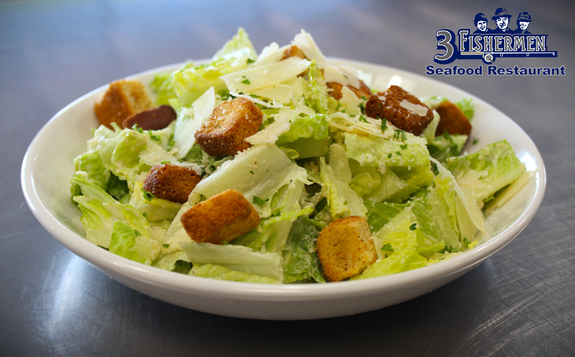 A close up of a caesar salad in a white bowl