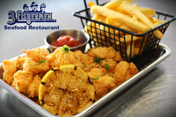 A tray of fried shrimp and french fries from a seafood restaurant