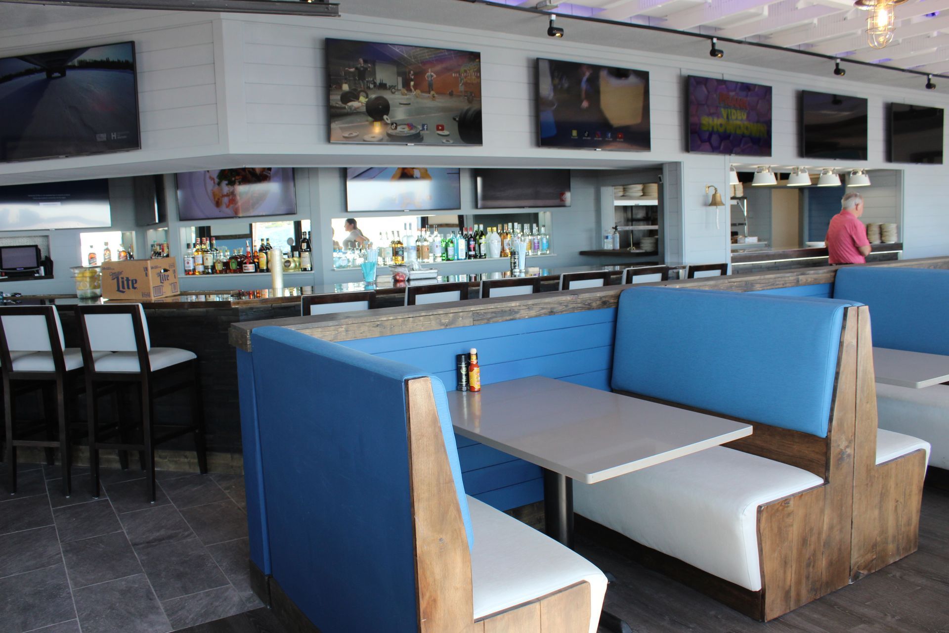 A restaurant with blue booths and white tables