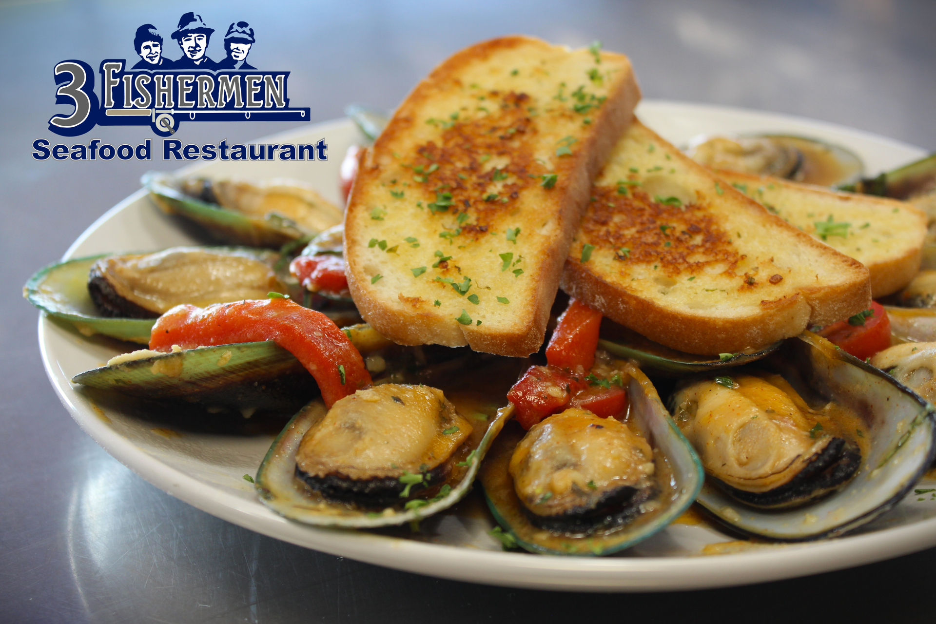 A white plate topped with mussels and garlic bread from a seafood restaurant