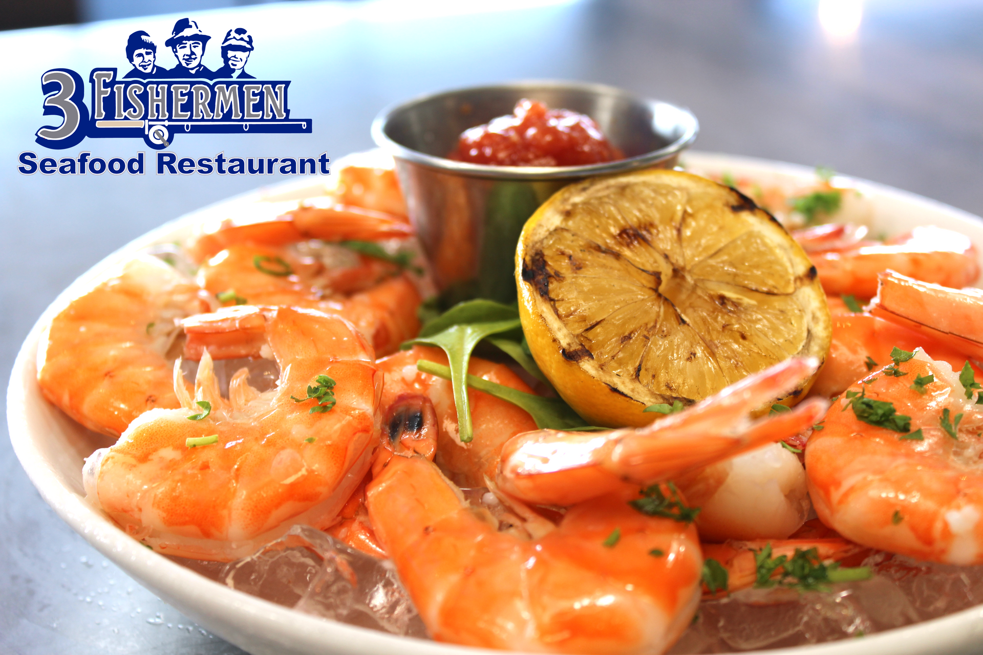 A plate of shrimp with a slice of lemon and ketchup from the fishermen seafood restaurant