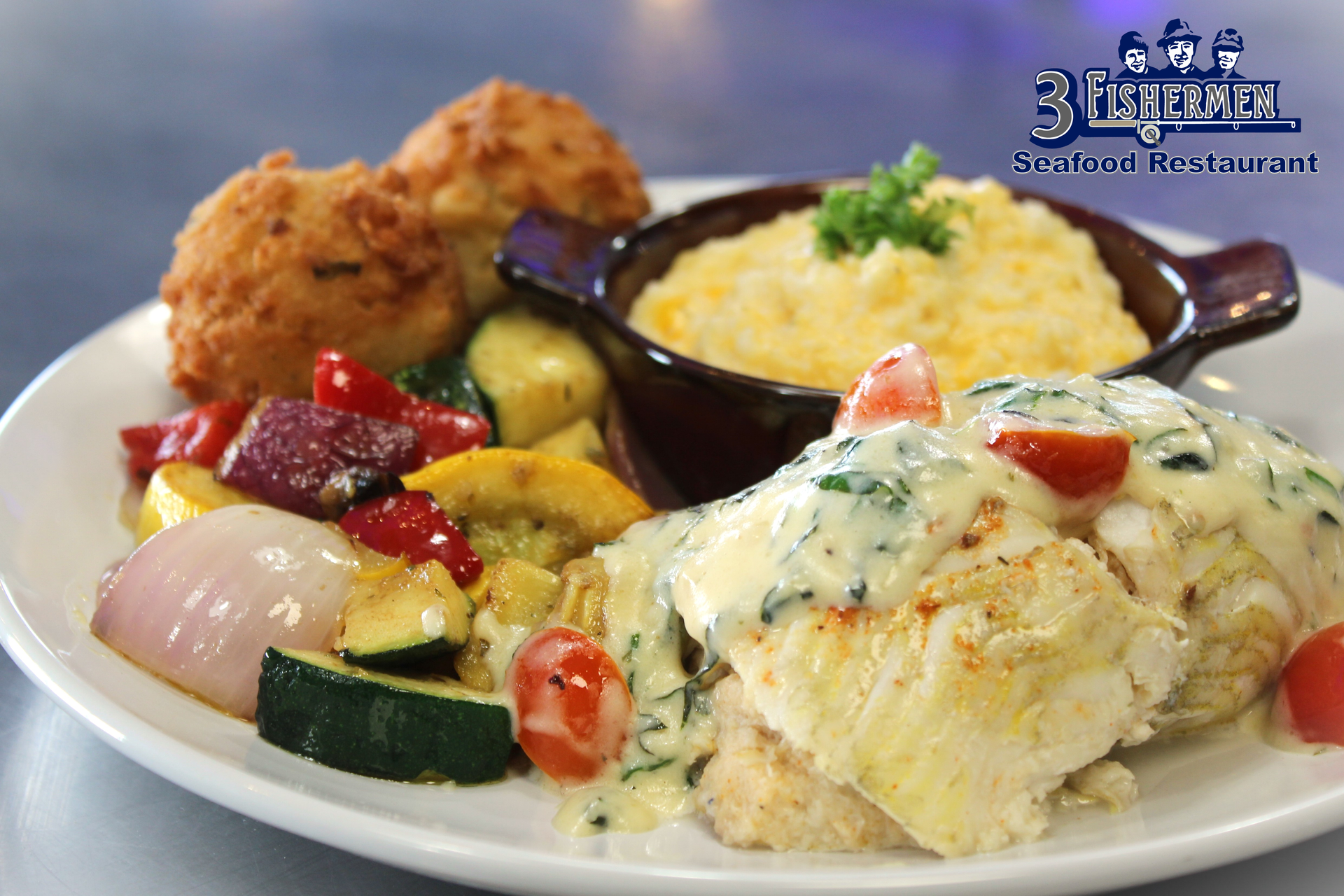 A plate of food with a bowl of mashed potatoes on the side
