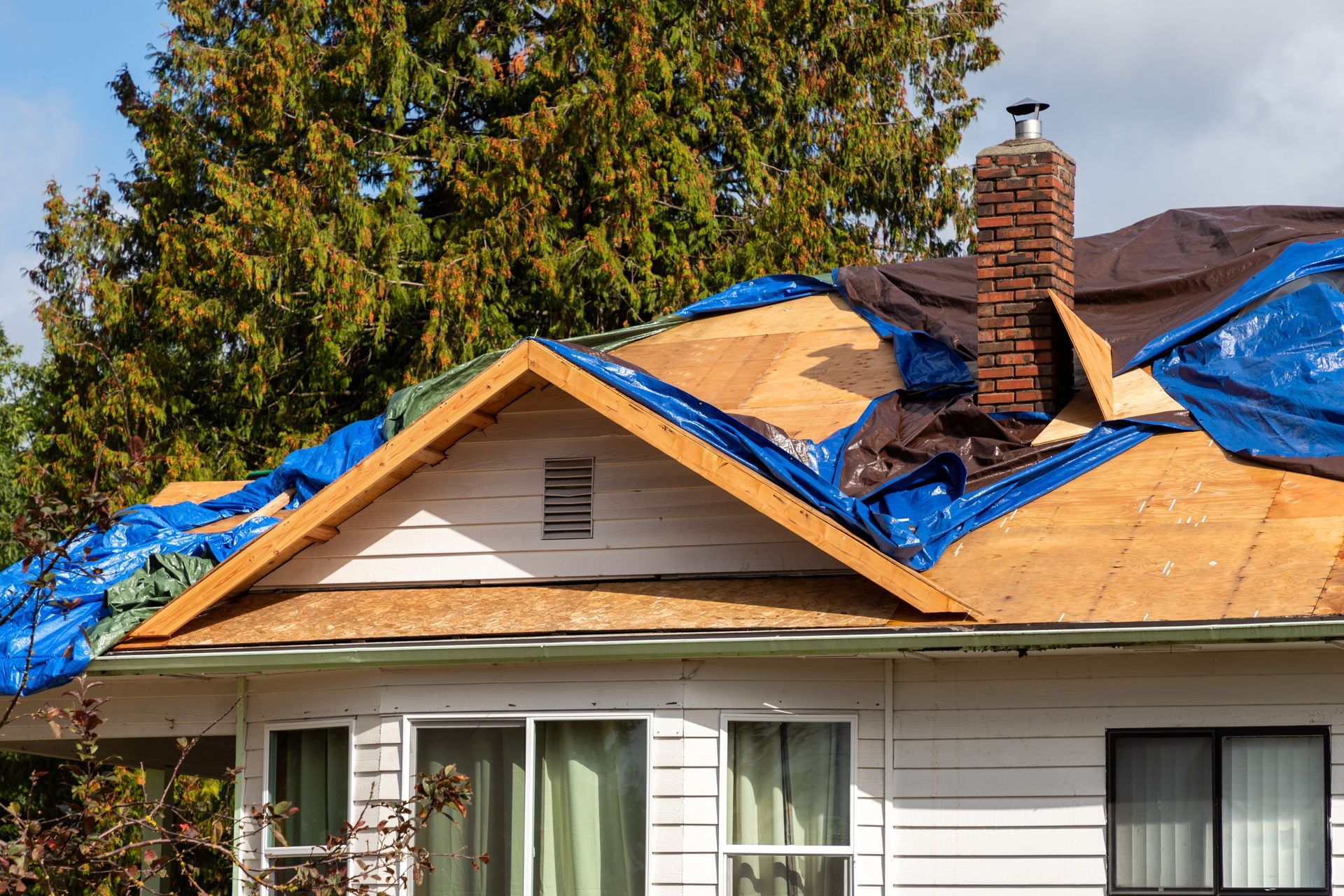 Photograph of a house roof undergoing repairs