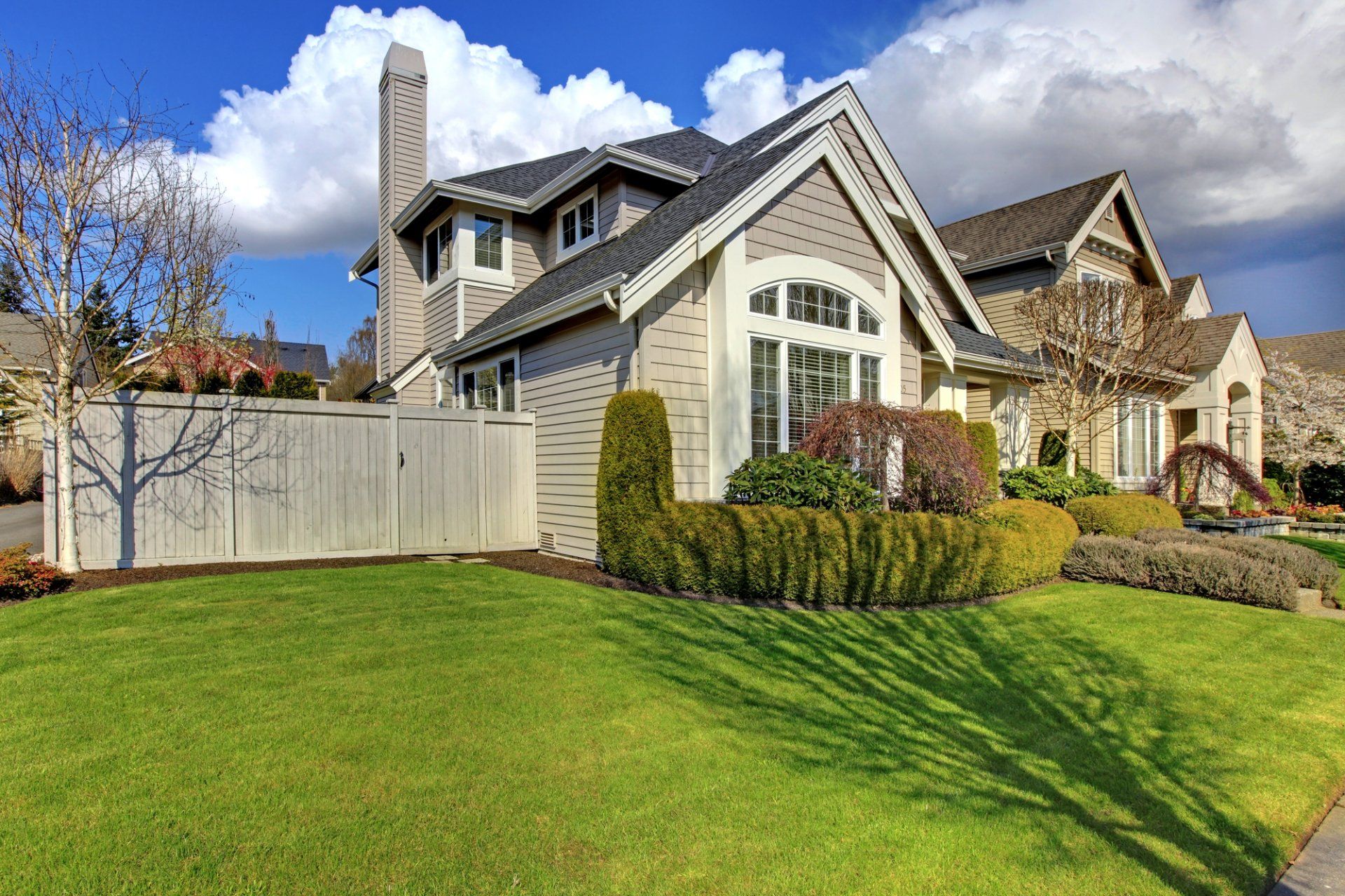 A large house with a lush green lawn in front of it.