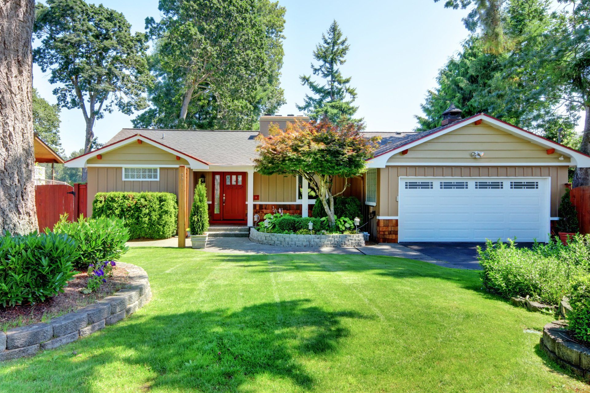 A house with a large lawn and a white garage door.