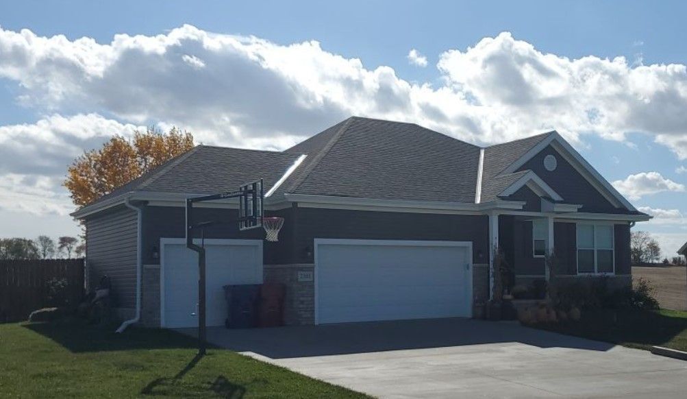 A house with a basketball hoop in front of it