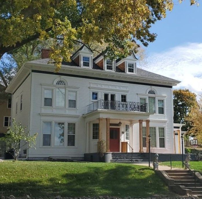 A large white house with stairs leading up to it